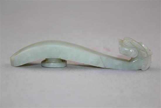 A Chinese pale celadon jade belt hook, 19th century, 9.8cm.